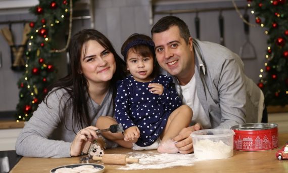 a man, woman and child are sitting at a table